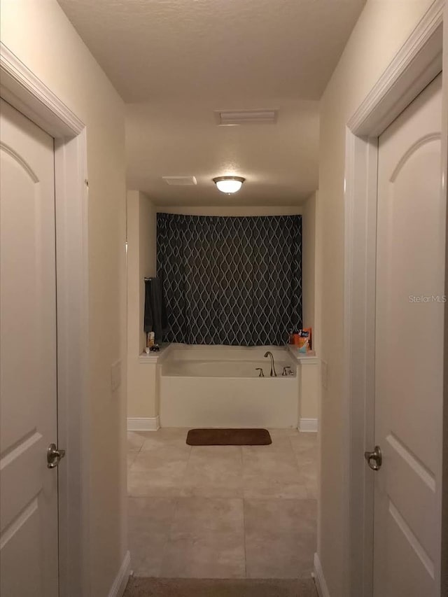 9007 49th Ave E, Palmetto, FL 34221 - hall with baseboards and light tile patterned floors