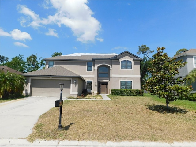 9007 49th Ave E, Palmetto, FL 34221 - traditional-style home featuring stucco siding, an attached garage, driveway, and a front yard