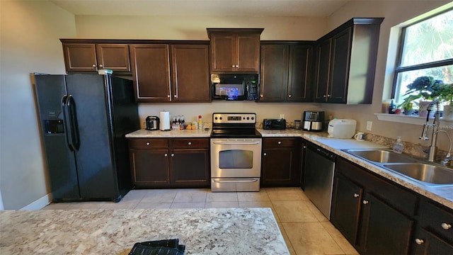 9007 49th Ave E, Palmetto, FL 34221 - kitchen featuring black appliances, a sink, light tile patterned floors, and dark brown cabinets