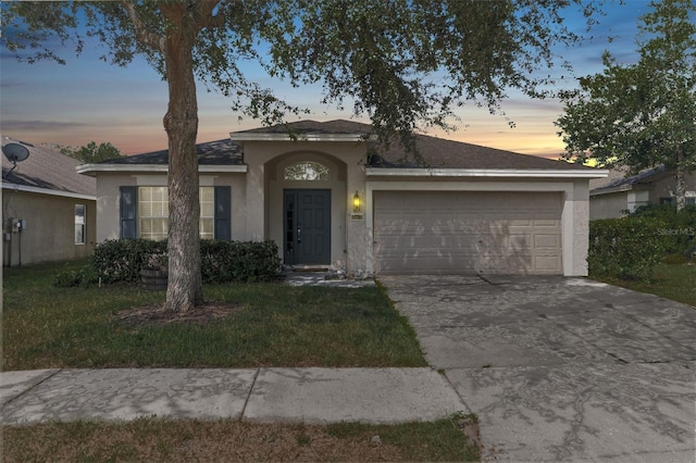 single story home with a garage, driveway, and stucco siding