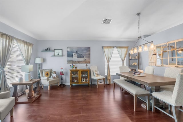 dining room featuring visible vents, plenty of natural light, and wood finished floors