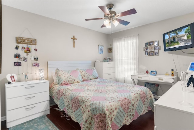 bedroom featuring multiple windows, dark wood finished floors, and ceiling fan