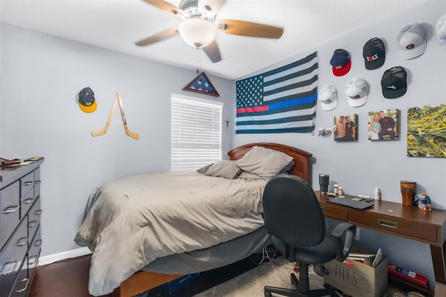 bedroom featuring baseboards, ceiling fan, and wood finished floors