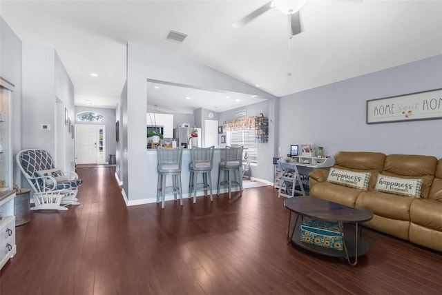 living area with visible vents, ceiling fan, wood finished floors, and lofted ceiling
