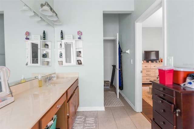 bathroom featuring vanity, baseboards, and tile patterned floors