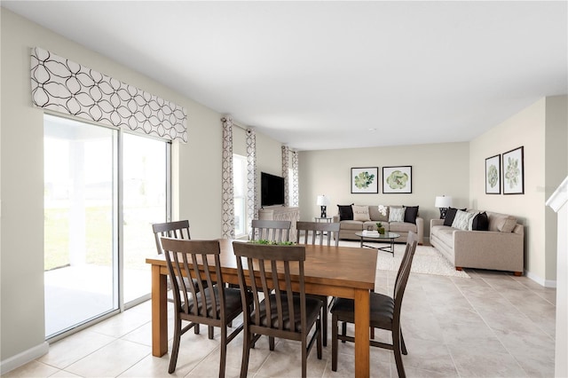 dining room with light tile patterned floors and baseboards