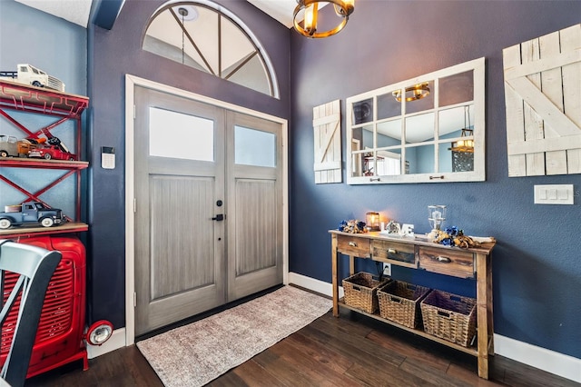 foyer entrance featuring wood finished floors and baseboards