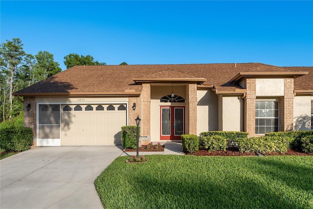 view of front of property featuring a garage, a shingled roof, driveway, and a front lawn