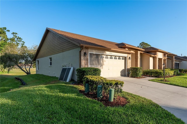 view of property exterior featuring brick siding, a garage, a yard, and driveway