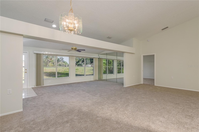 unfurnished living room featuring carpet floors, ceiling fan with notable chandelier, and visible vents