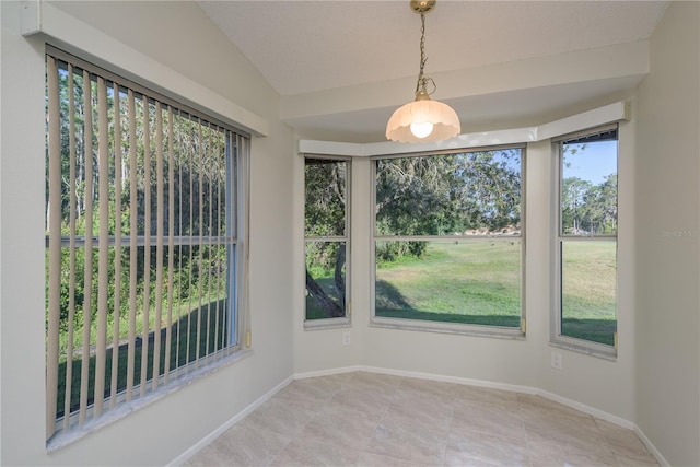 unfurnished room featuring baseboards, tile patterned flooring, and vaulted ceiling