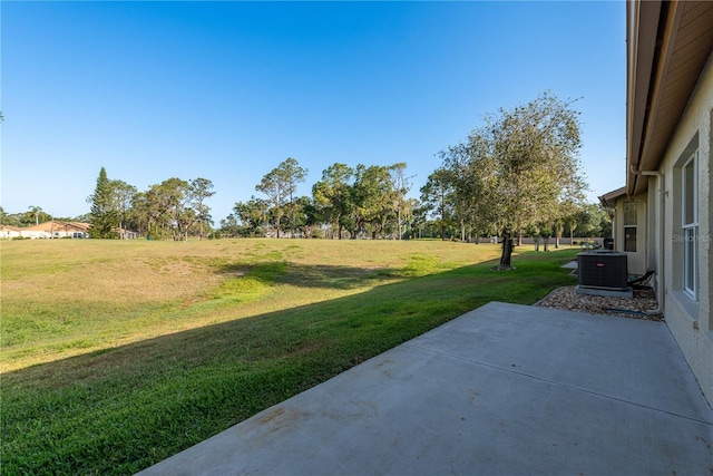 view of yard featuring central AC and a patio area