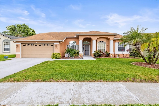 12040 Penzance Ln, New Port Richey, FL 34654 - mediterranean / spanish home featuring a garage, stucco siding, driveway, and a front lawn