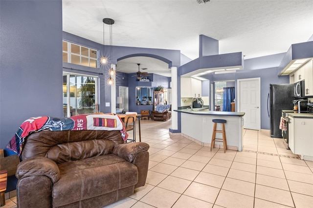 12040 Penzance Ln, New Port Richey, FL 34654 - living area with plenty of natural light, ceiling fan, and light tile patterned flooring