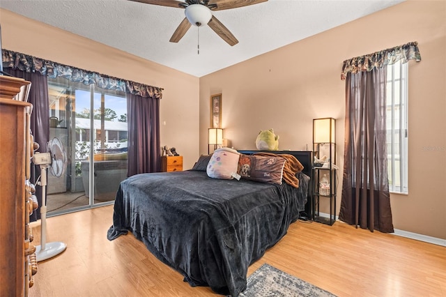 12040 Penzance Ln, New Port Richey, FL 34654 - bedroom featuring baseboards, a ceiling fan, light wood finished floors, and access to exterior