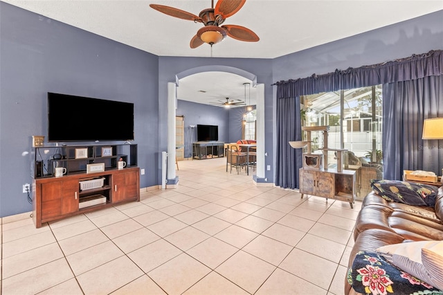 12040 Penzance Ln, New Port Richey, FL 34654 - living room with arched walkways, ceiling fan, and light tile patterned flooring