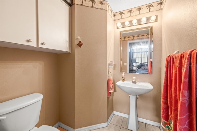 12040 Penzance Ln, New Port Richey, FL 34654 - bathroom with toilet, baseboards, and tile patterned floors