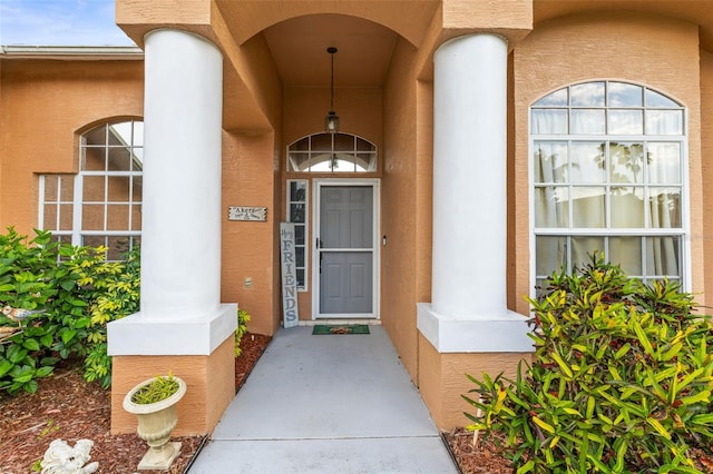12040 Penzance Ln, New Port Richey, FL 34654 - property entrance featuring a porch and stucco siding