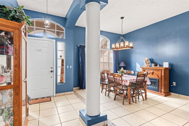 12040 Penzance Ln, New Port Richey, FL 34654 - tiled entrance foyer featuring a chandelier, arched walkways, baseboards, and ornate columns
