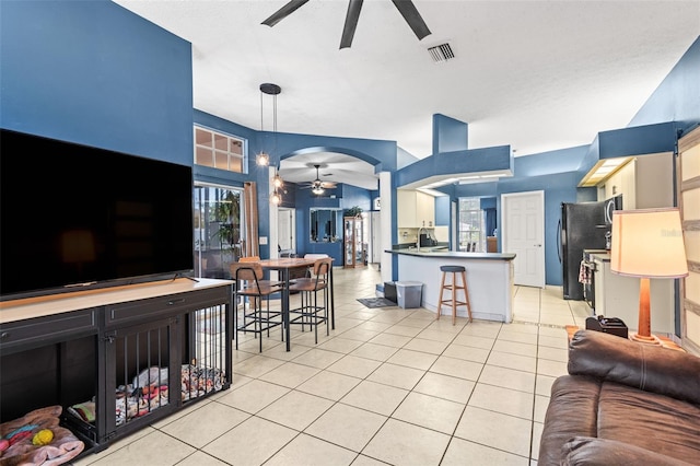 12040 Penzance Ln, New Port Richey, FL 34654 - living room featuring a ceiling fan, light tile patterned floors, and arched walkways