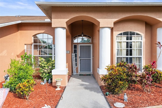 12040 Penzance Ln, New Port Richey, FL 34654 - doorway to property featuring stucco siding and a porch