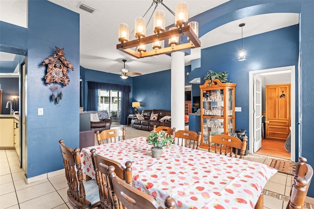 12040 Penzance Ln, New Port Richey, FL 34654 - dining area with light tile patterned flooring, a ceiling fan, and a chandelier