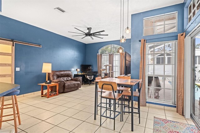 12040 Penzance Ln, New Port Richey, FL 34654 - dining room with an office area, a ceiling fan, light tile patterned flooring, and a barn door