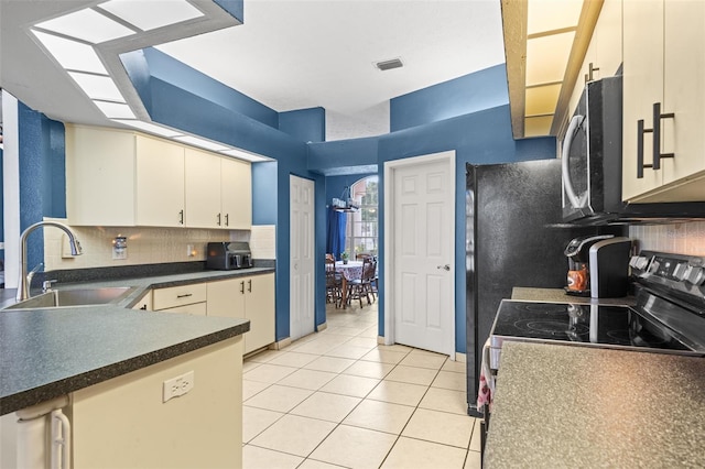 12040 Penzance Ln, New Port Richey, FL 34654 - kitchen featuring a sink, electric range, light tile patterned flooring, dark countertops, and tasteful backsplash