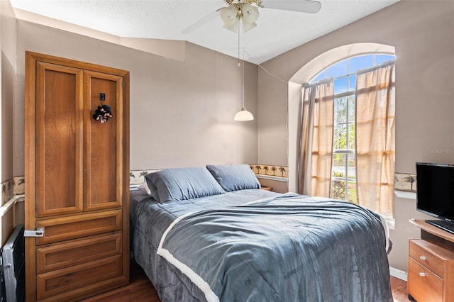 12040 Penzance Ln, New Port Richey, FL 34654 - bedroom with wood finished floors and a ceiling fan