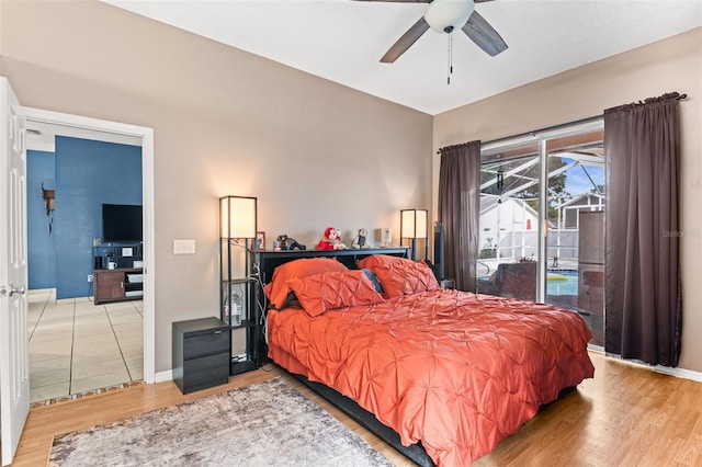 12040 Penzance Ln, New Port Richey, FL 34654 - bedroom featuring access to exterior, wood finished floors, ceiling fan, and baseboards