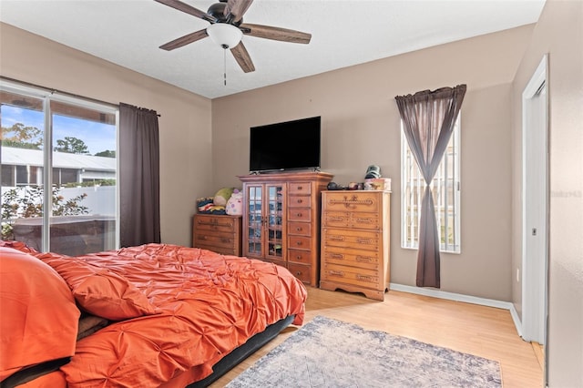12040 Penzance Ln, New Port Richey, FL 34654 - bedroom with wood finished floors, baseboards, and ceiling fan