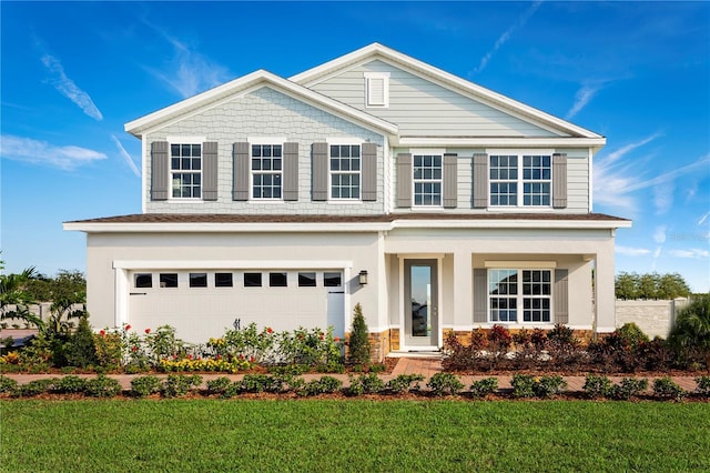 traditional-style house featuring covered porch, an attached garage, and a front lawn