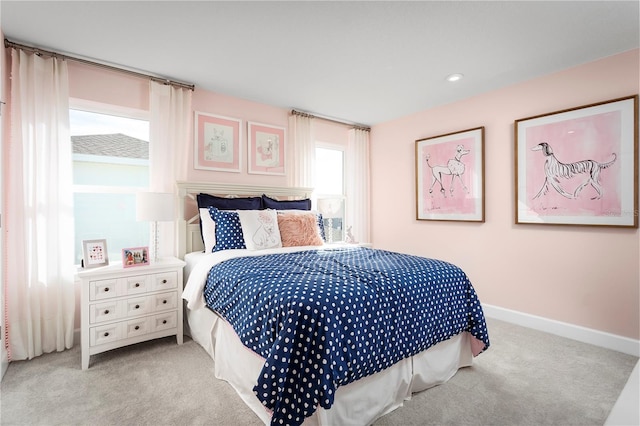 carpeted bedroom featuring baseboards