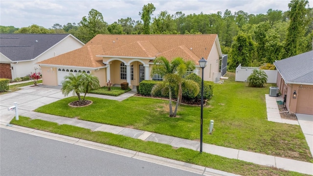 7827 Starfire Way, New Port Richey, FL 34654 - mediterranean / spanish house featuring cooling unit, a garage, driveway, and a front lawn
