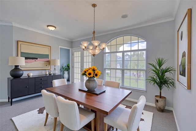 7827 Starfire Way, New Port Richey, FL 34654 - dining space featuring carpet flooring, a chandelier, baseboards, and crown molding