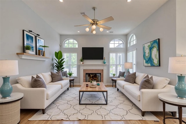 7827 Starfire Way, New Port Richey, FL 34654 - living area with a ceiling fan, wood finished floors, recessed lighting, and a brick fireplace