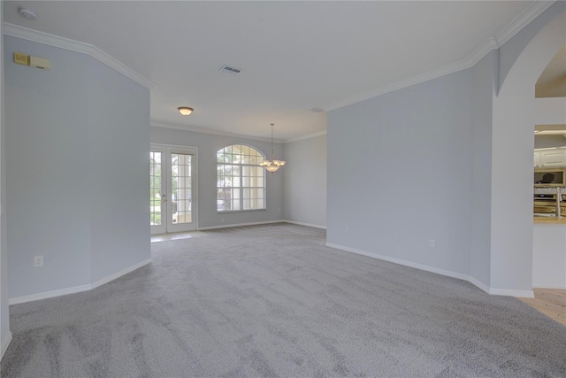7827 Starfire Way, New Port Richey, FL 34654 - empty room with arched walkways, ornamental molding, a chandelier, and baseboards