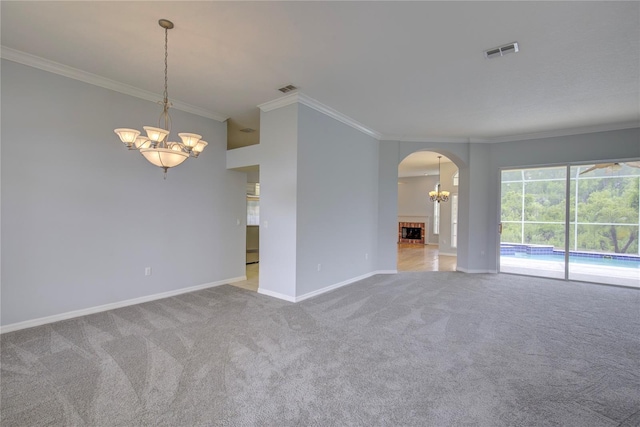 7827 Starfire Way, New Port Richey, FL 34654 - carpeted spare room featuring a chandelier, crown molding, arched walkways, and baseboards