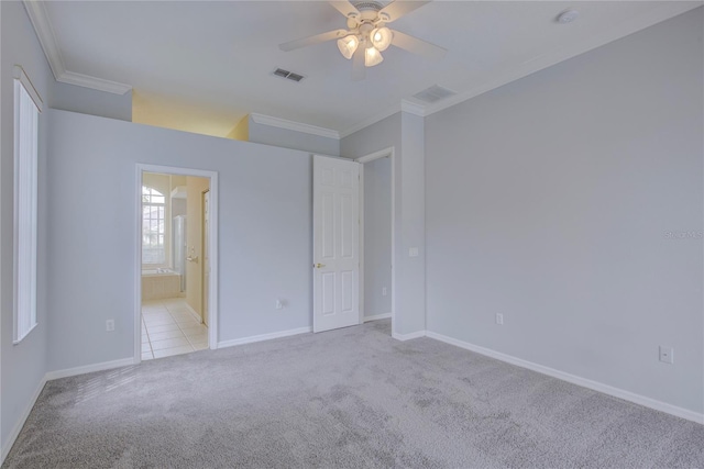 7827 Starfire Way, New Port Richey, FL 34654 - unfurnished bedroom with crown molding, light carpet, baseboards, ensuite bathroom, and a ceiling fan