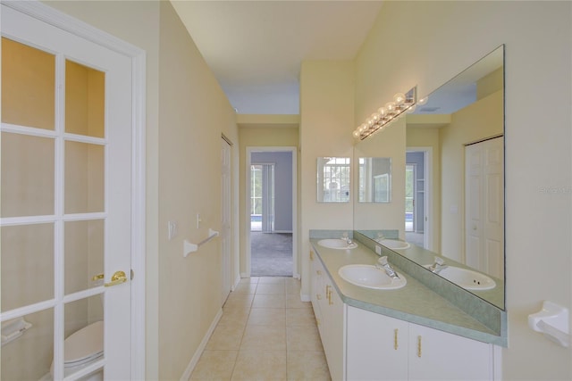 7827 Starfire Way, New Port Richey, FL 34654 - full bath with tile patterned flooring, double vanity, and baseboards