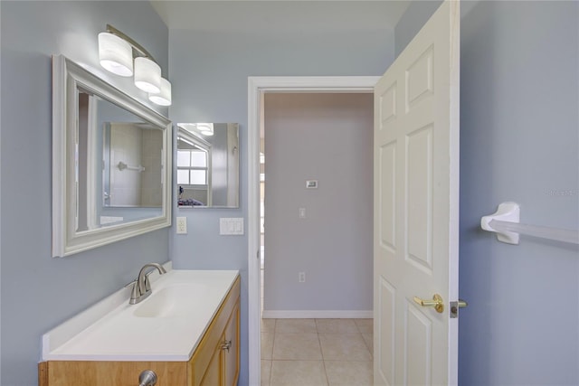 7827 Starfire Way, New Port Richey, FL 34654 - bathroom with vanity, tile patterned flooring, and baseboards