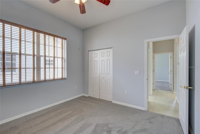 7827 Starfire Way, New Port Richey, FL 34654 - unfurnished bedroom featuring carpet, a closet, baseboards, and a ceiling fan