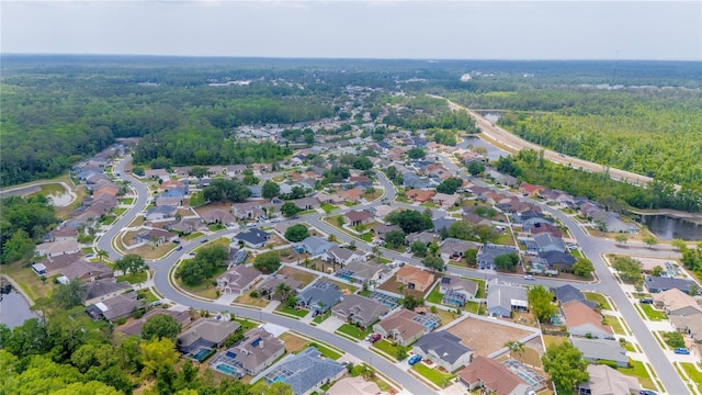 7827 Starfire Way, New Port Richey, FL 34654 - aerial view of property's location featuring a forest, nearby suburban area, and a large body of water