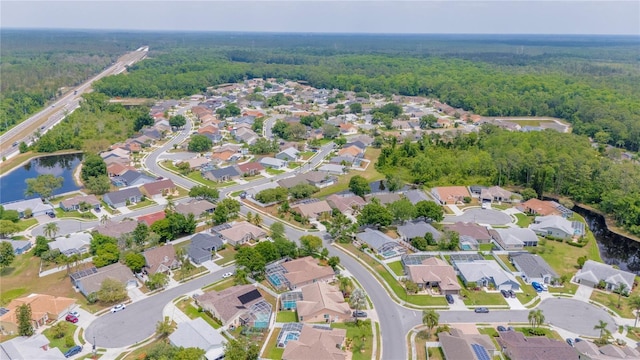7827 Starfire Way, New Port Richey, FL 34654 - aerial overview of property's location featuring a forest, nearby suburban area, and a large body of water