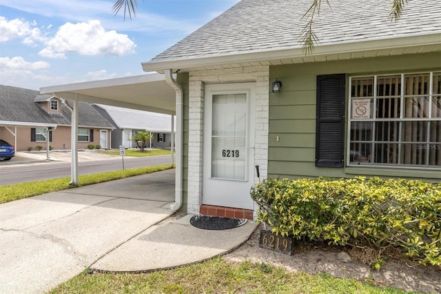 6219 Wilds Dr Unit 11A, New Port Richey, FL 34653 - entrance to property featuring a shingled roof and an attached carport