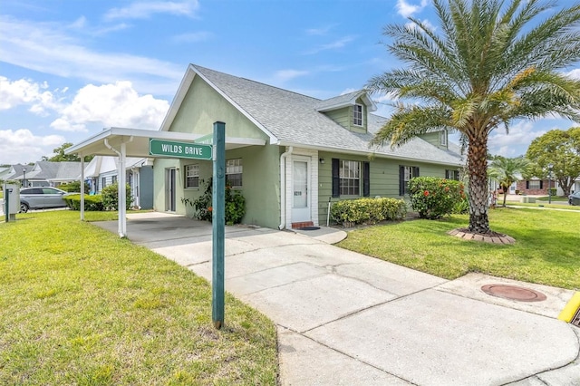 6219 Wilds Dr Unit 11A, New Port Richey, FL 34653 - view of front facade with a front yard, an attached carport, roof with shingles, and concrete driveway