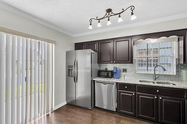 6219 Wilds Dr Unit 11A, New Port Richey, FL 34653 - kitchen featuring stainless steel appliances, a sink, dark wood finished floors, decorative backsplash, and ornamental molding