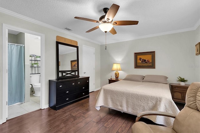 6219 Wilds Dr Unit 11A, New Port Richey, FL 34653 - bedroom with wood finished floors, crown molding, ensuite bath, ceiling fan, and baseboards
