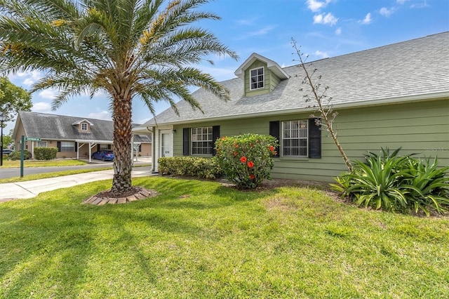 6219 Wilds Dr Unit 11A, New Port Richey, FL 34653 - view of front facade featuring a front lawn, driveway, and roof with shingles