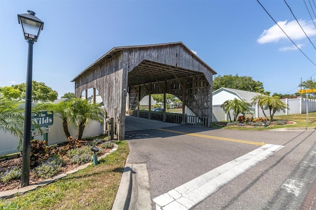 6219 Wilds Dr Unit 11A, New Port Richey, FL 34653 - view of car parking featuring fence and a detached carport